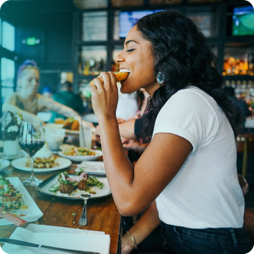 Image displaying a diner enjoying her meal ordered from restaurants mouth-watering photo menu